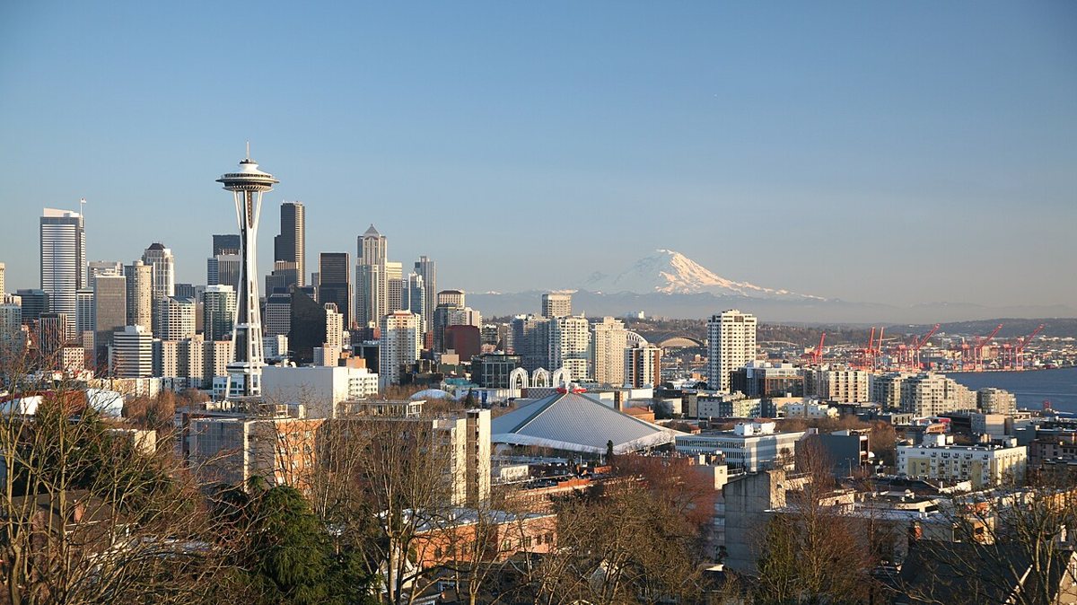 Couple watching the sunset skyline view of downtown Seattle and Mount Rainier from Kerry Park on Queen Anne